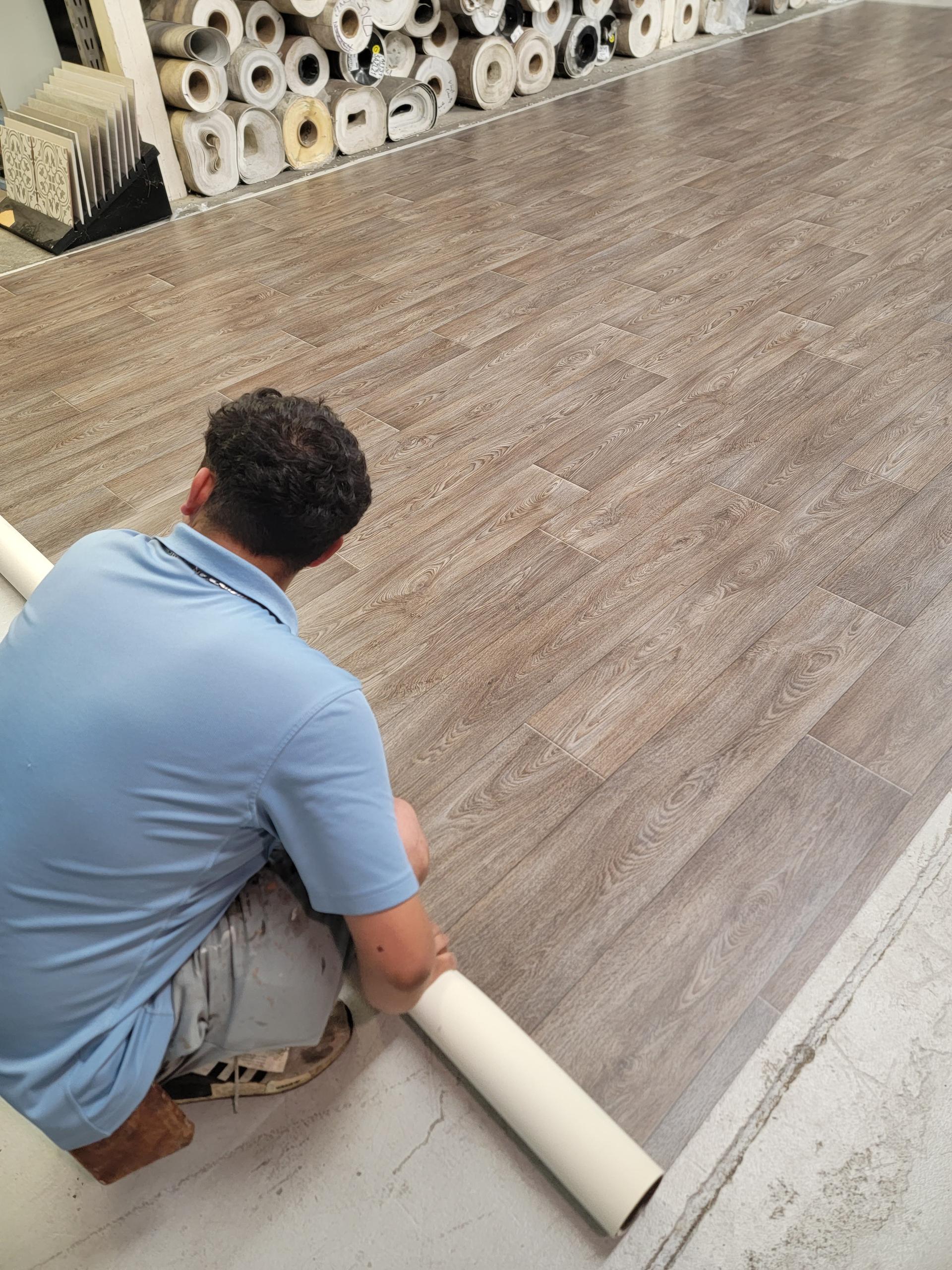 Flooring professional preparing wood-look laminate planks